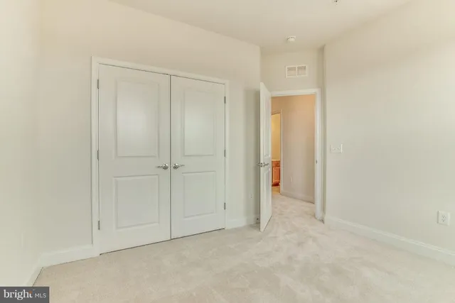 an empty room with closet area