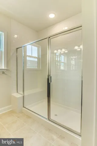 a bathroom with a glass shower door