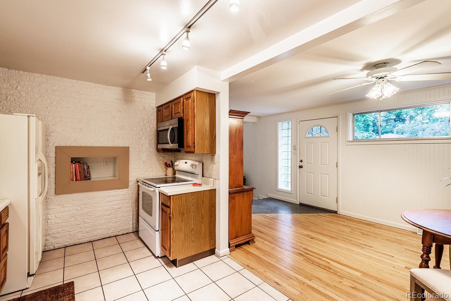 13895 Braun Road Golden, CO 80401 - Photo 11 of 40 a kitchen with granite countertop a stove top oven and cabinets