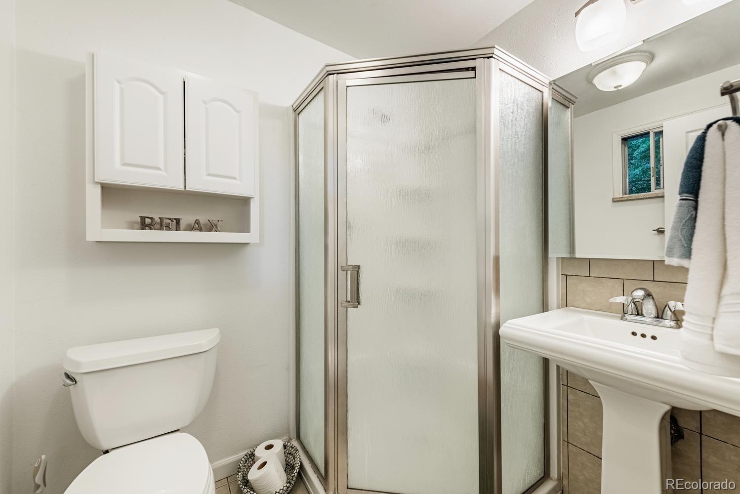 13895 Braun Road Golden, CO 80401 - Photo 16 of 40 a bathroom with a sink a toilet and shower
