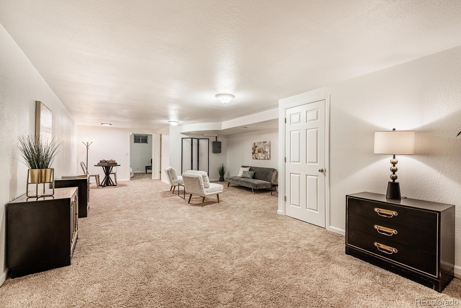 13895 Braun Road Golden, CO 80401 - Photo 21 of 40 a living room with furniture and a flat screen tv