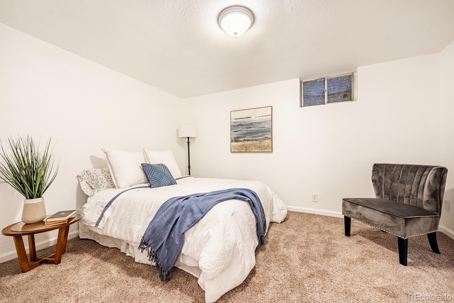 13895 Braun Road Golden, CO 80401 - Photo 25 of 40 a bedroom with a bed and a couch
