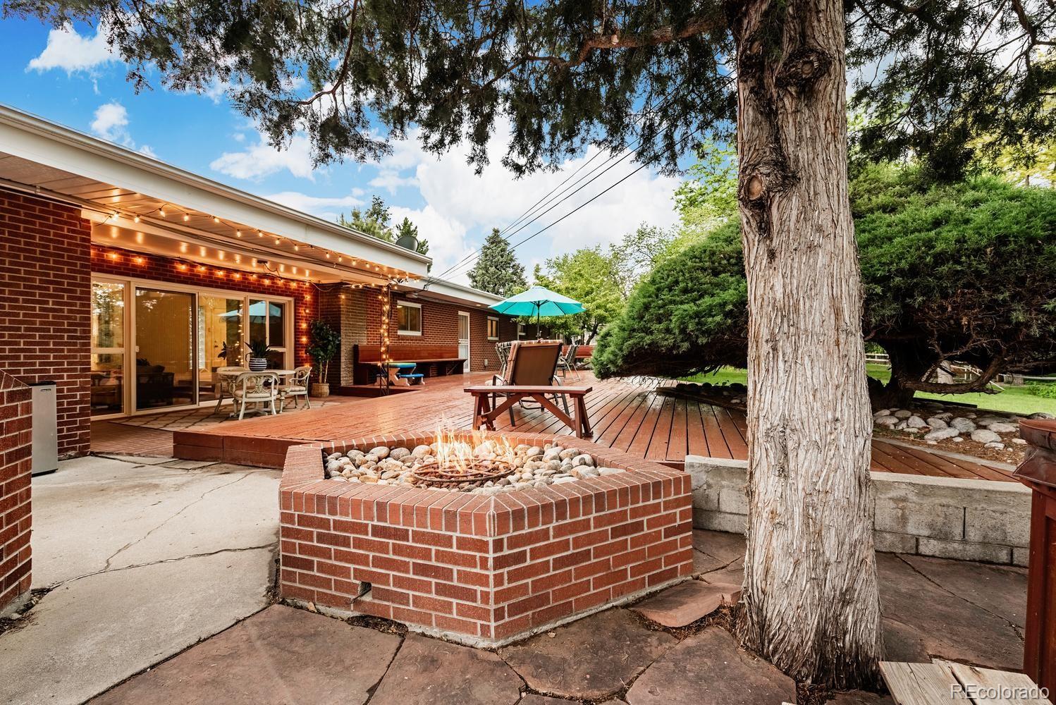 13895 Braun Road Golden, CO 80401 - Photo 28 of 40 a view of a patio with table and chairs with wooden floor and fence