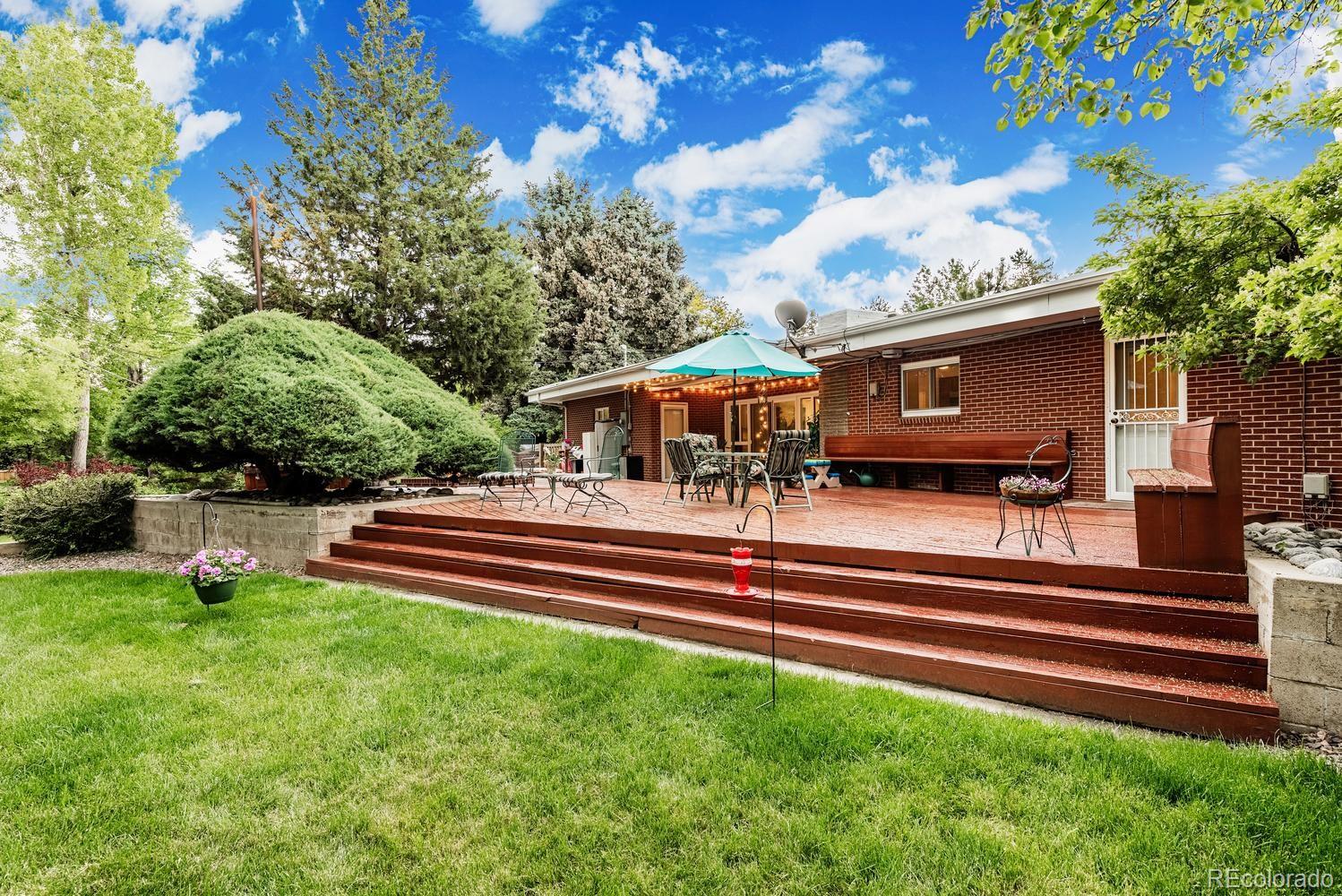 13895 Braun Road Golden, CO 80401 - Photo 31 of 40 a front view of a house with a garden and outdoor seating