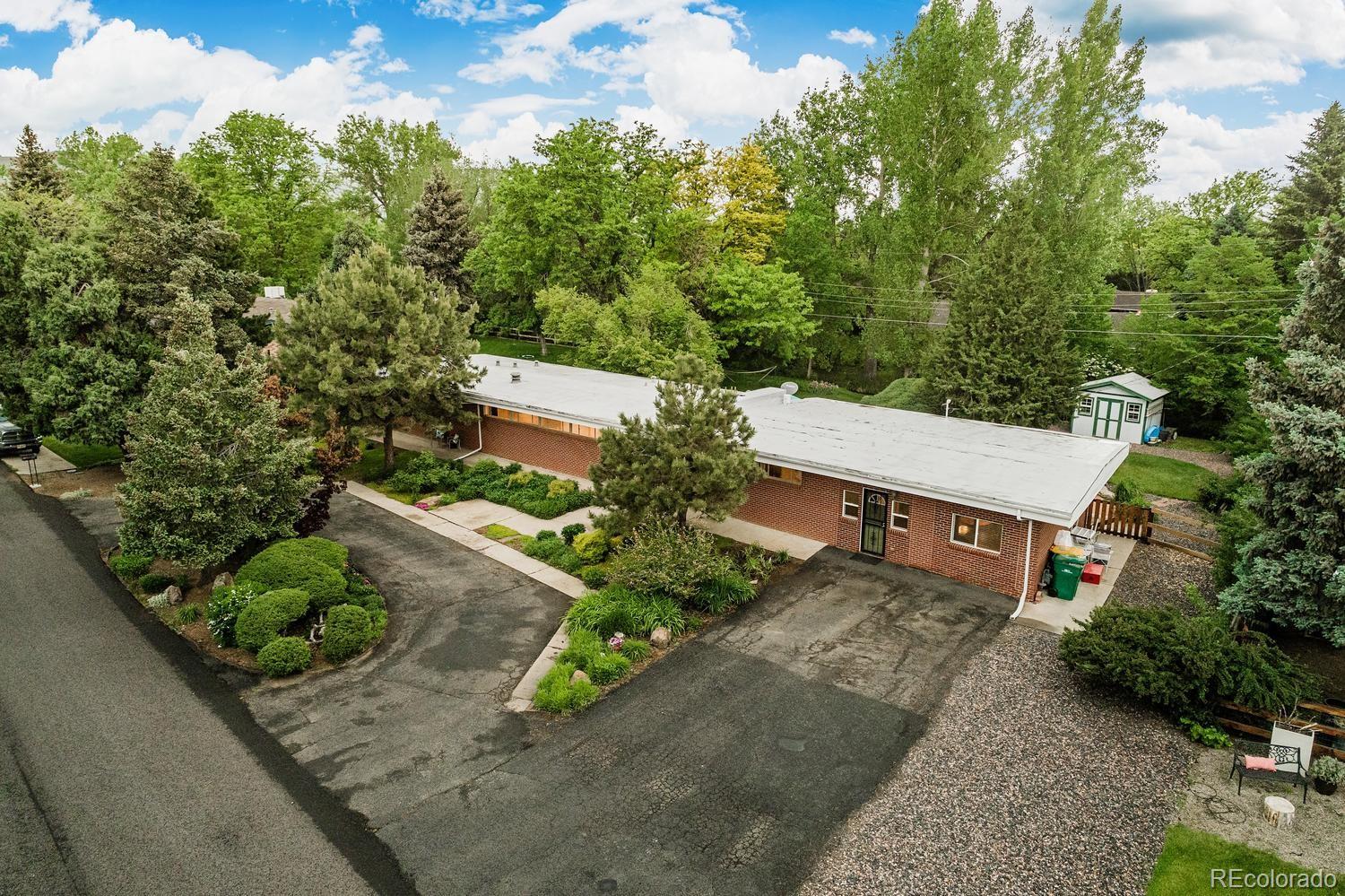 13895 Braun Road Golden, CO 80401 - Photo 36 of 40 an aerial view of a house with a yard outdoor seating and mountain view in back