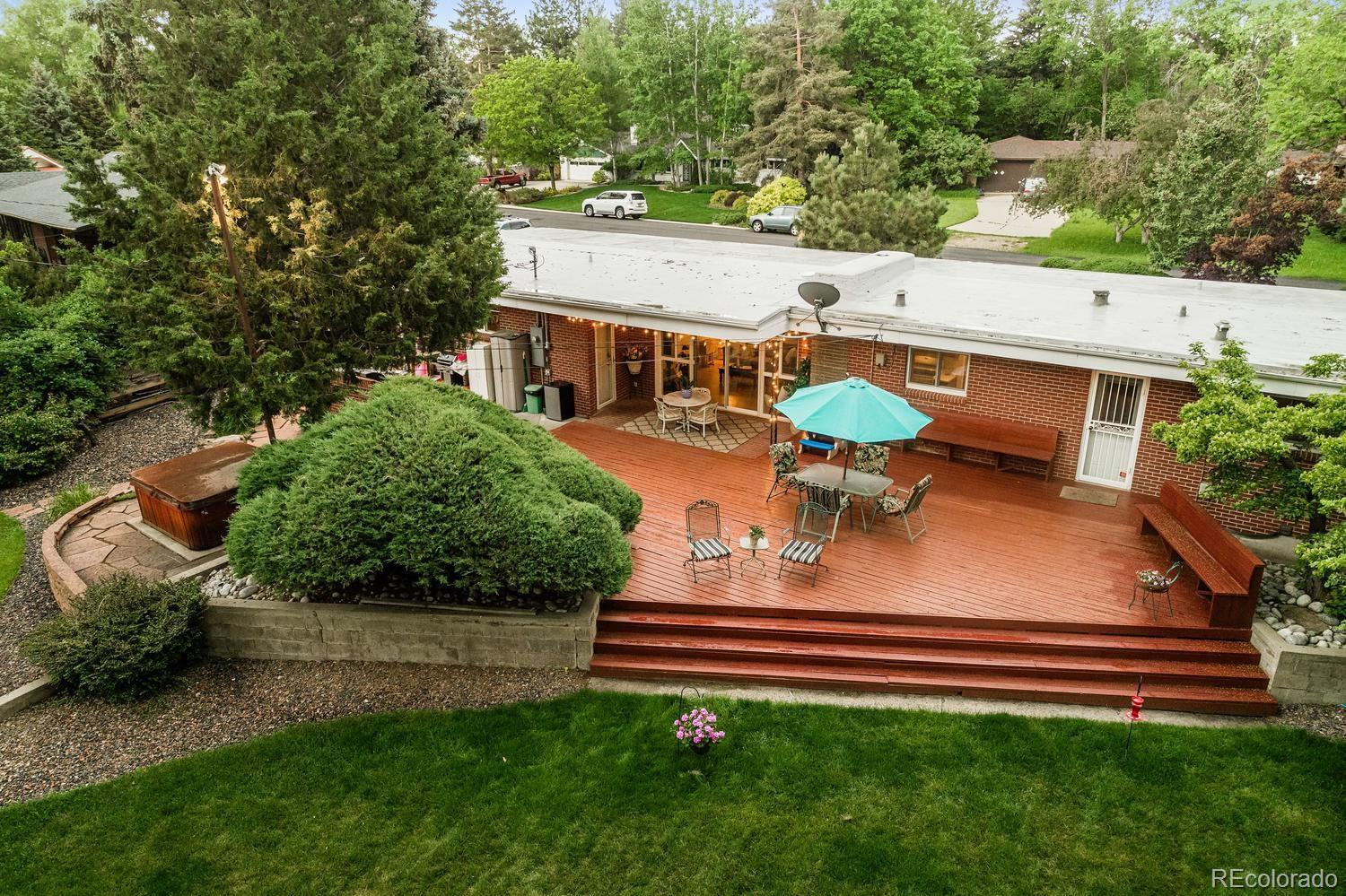 13895 Braun Road Golden, CO 80401 - Photo 39 of 40 a view of a patio with table and chairs with wooden fence