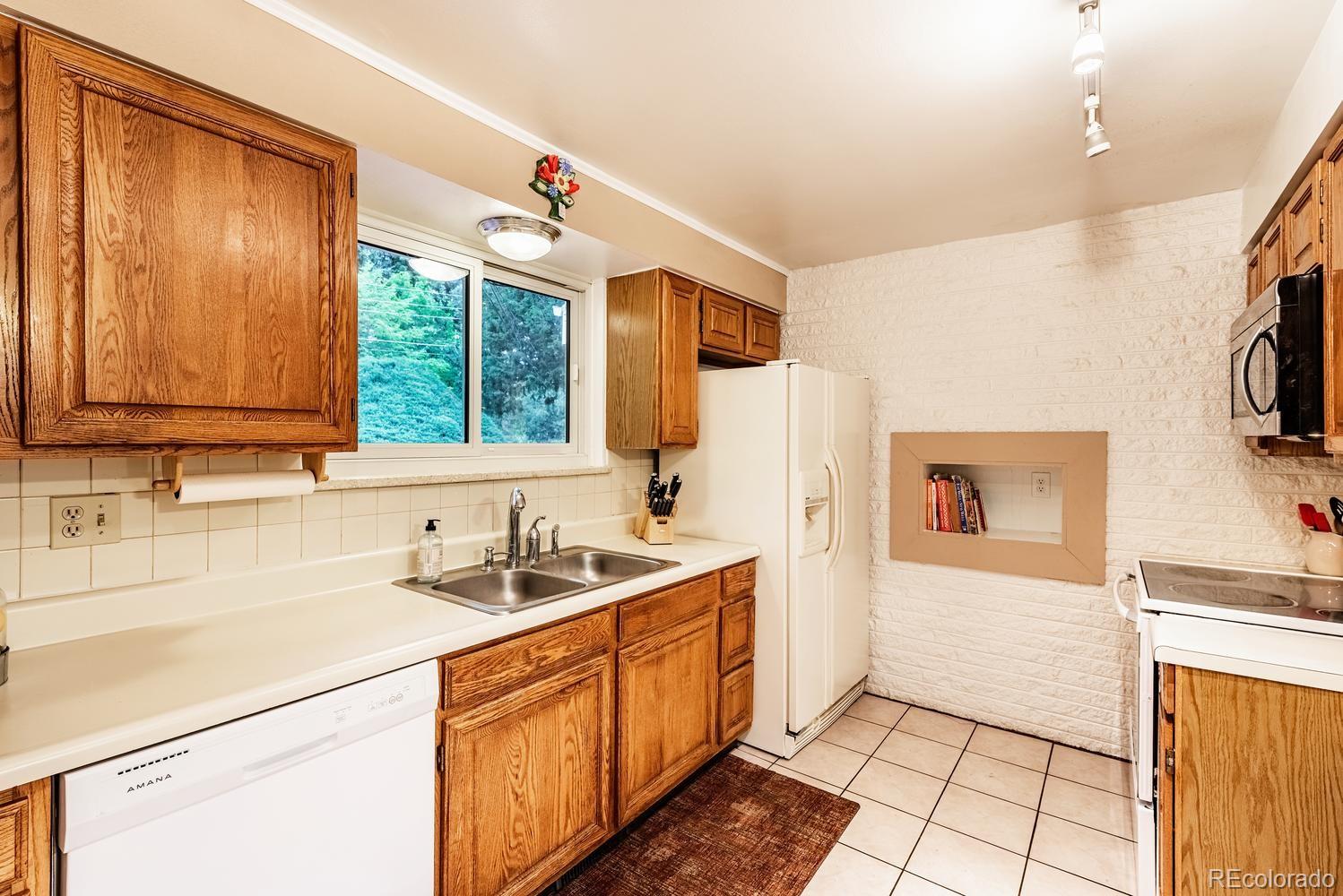 13895 Braun Road Golden, CO 80401 - Photo 10 of 40 a kitchen with a sink stove and microwave