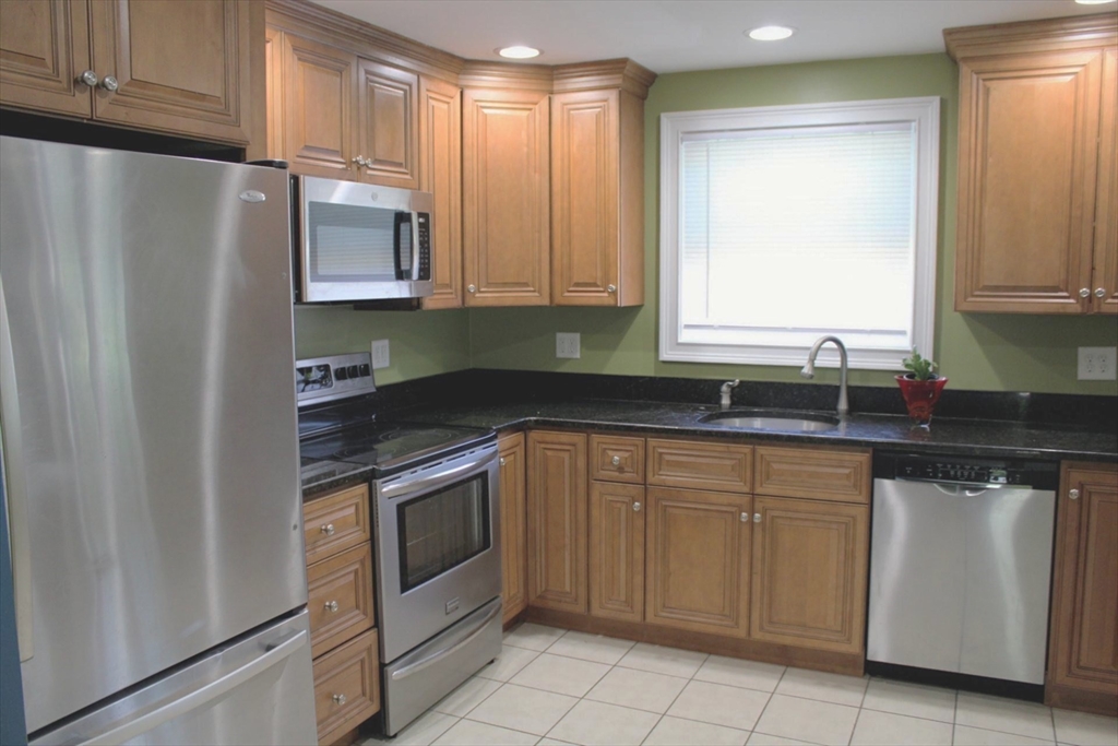 21 Whitcomb Drive Lancaster, MA 01523 - Photo 3 of 23 a kitchen with white cabinets and white appliances