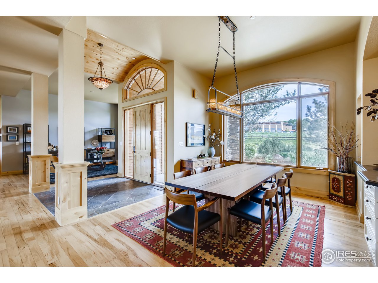 10484 Sunlight Drive Lafayette, CO 80026 - Photo 17 of 40 a view of a dining room with furniture window and wooden floor