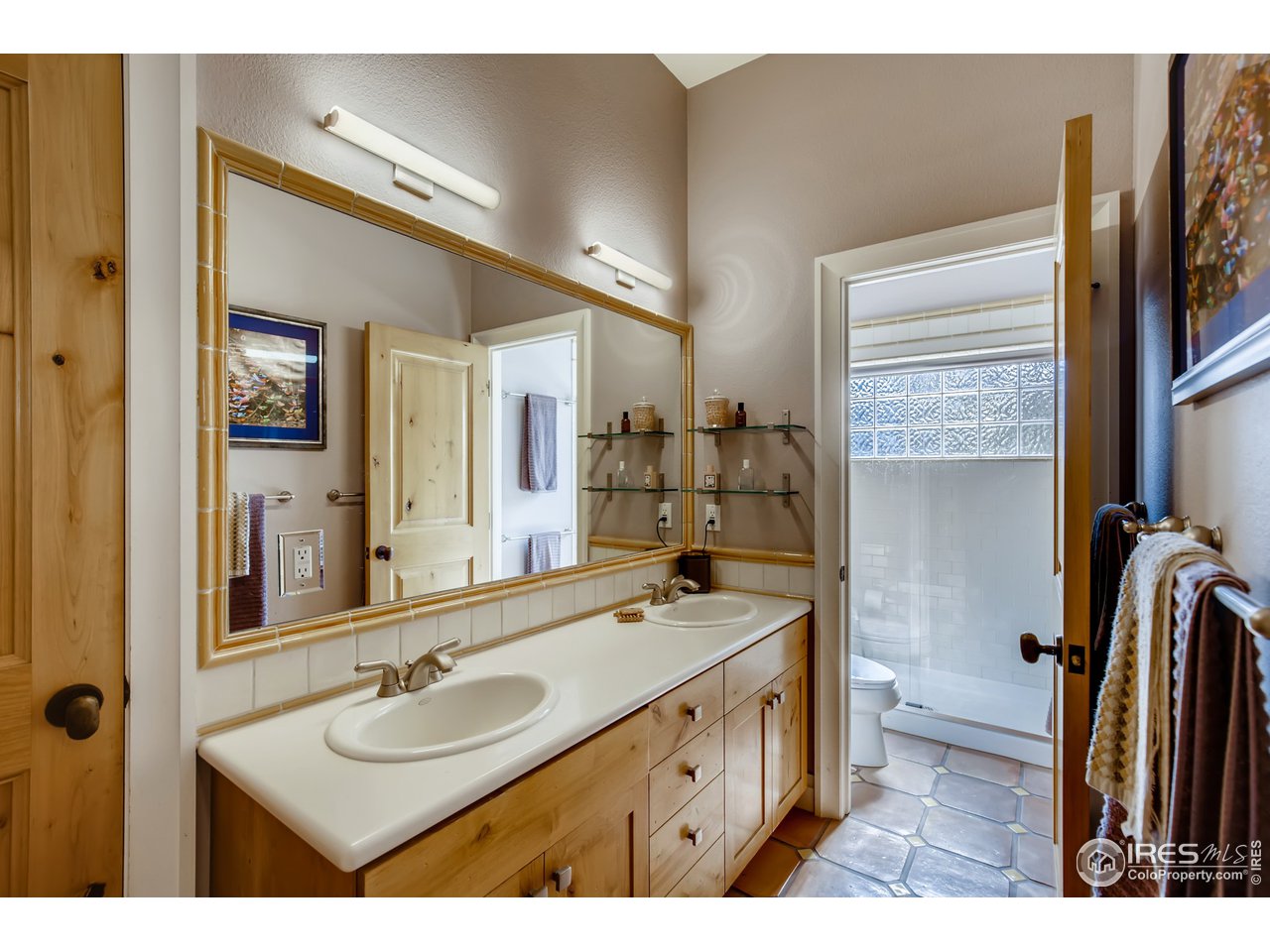 10484 Sunlight Drive Lafayette, CO 80026 - Photo 26 of 40 a bathroom with a sink double vanity granite and a shower