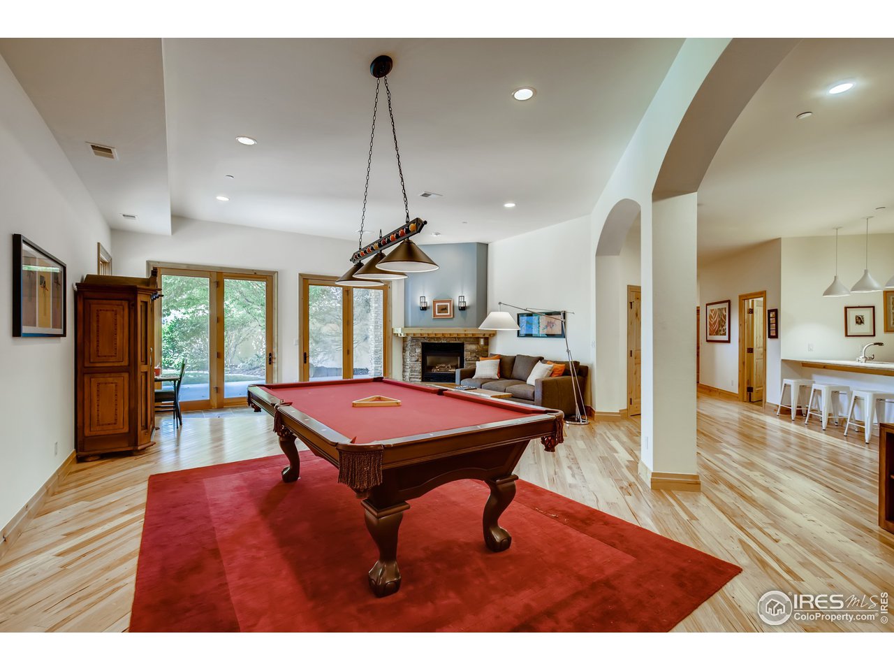 10484 Sunlight Drive Lafayette, CO 80026 - Photo 27 of 40 a room with furniture pool table flat screen tv and a chandelier