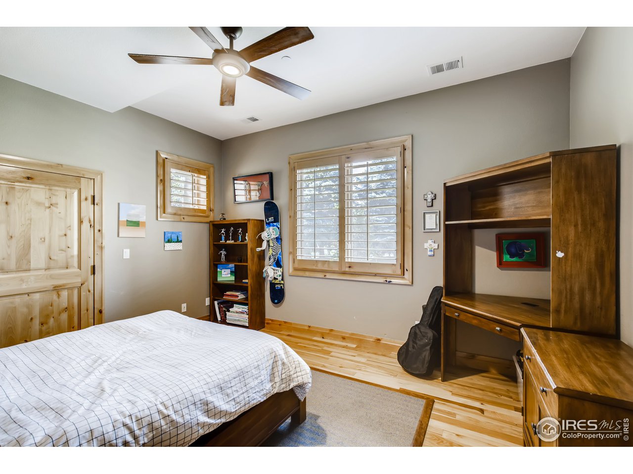 10484 Sunlight Drive Lafayette, CO 80026 - Photo 32 of 40 a bedroom with a bed and a chandelier