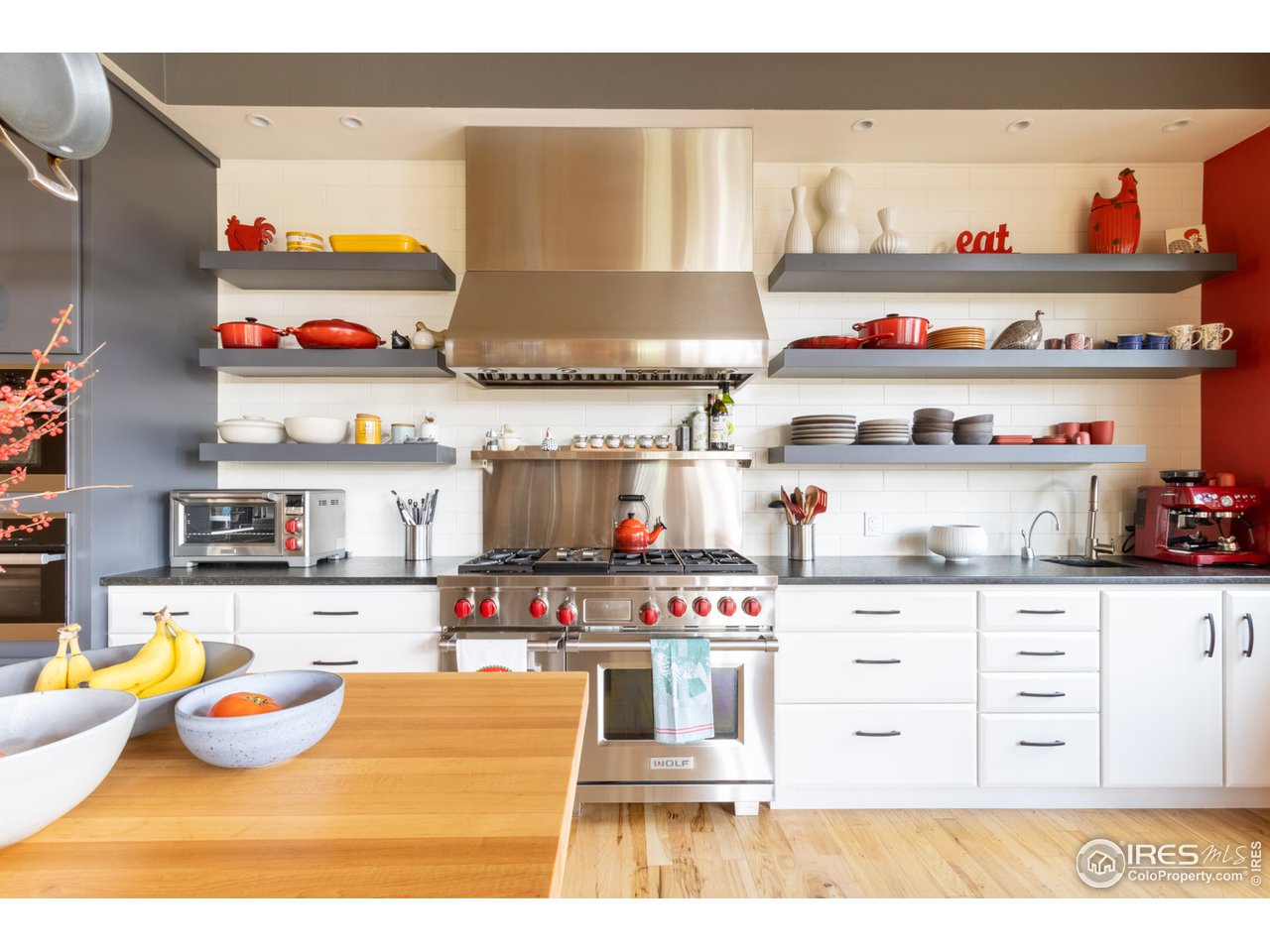 10484 Sunlight Drive Lafayette, CO 80026 - Photo 4 of 40 a kitchen with stainless steel appliances kitchen island granite countertop a stove and wooden cabinets