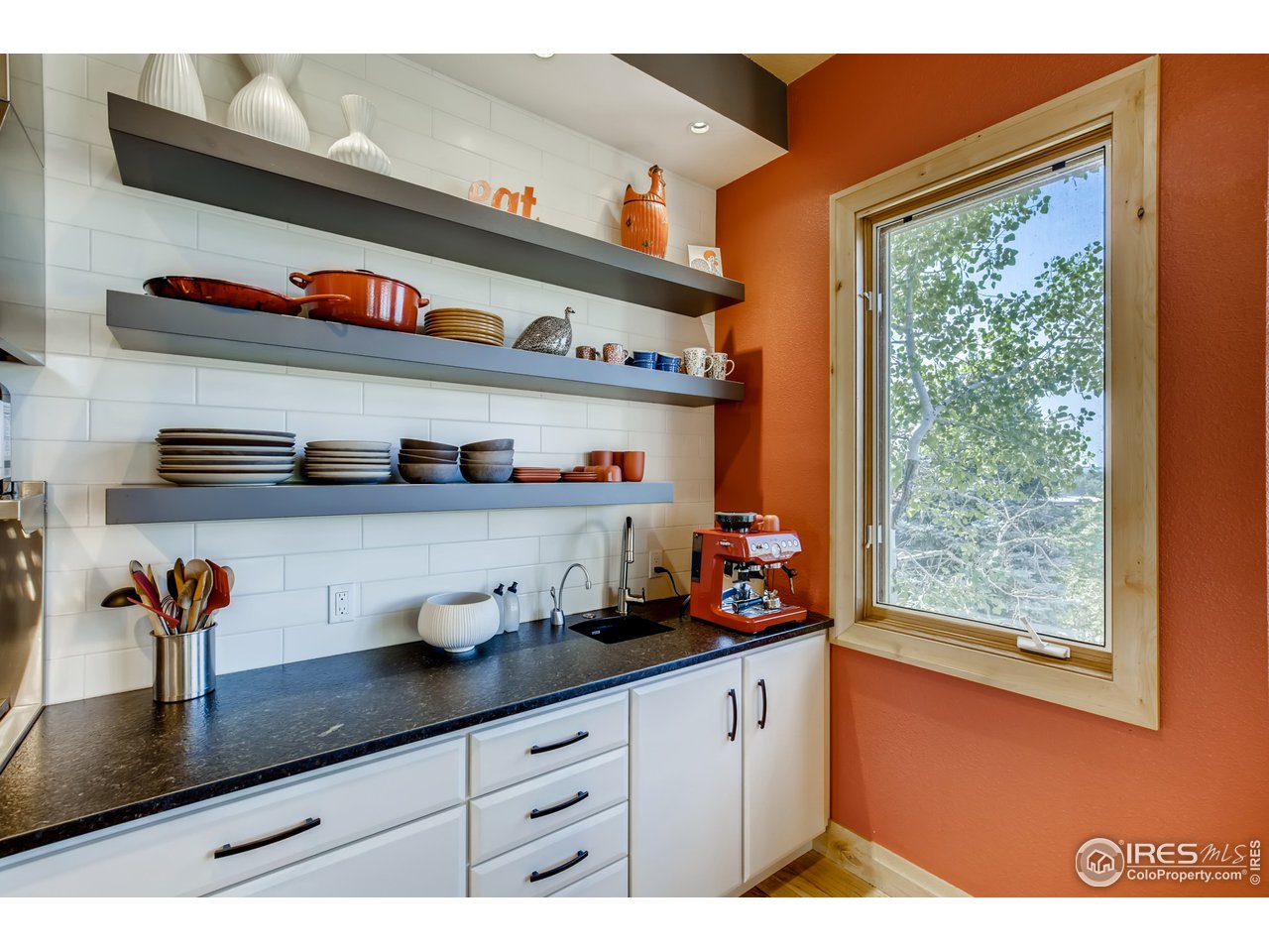10484 Sunlight Drive Lafayette, CO 80026 - Photo 10 of 40 a kitchen with lots of counter space cabinets and a wooden floor
