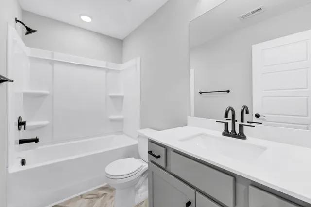 a bathroom with a sink a toilet and a bathtub