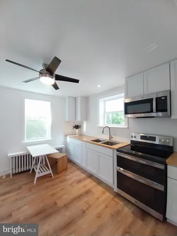 a kitchen with stainless steel appliances granite countertop a stove and a sink