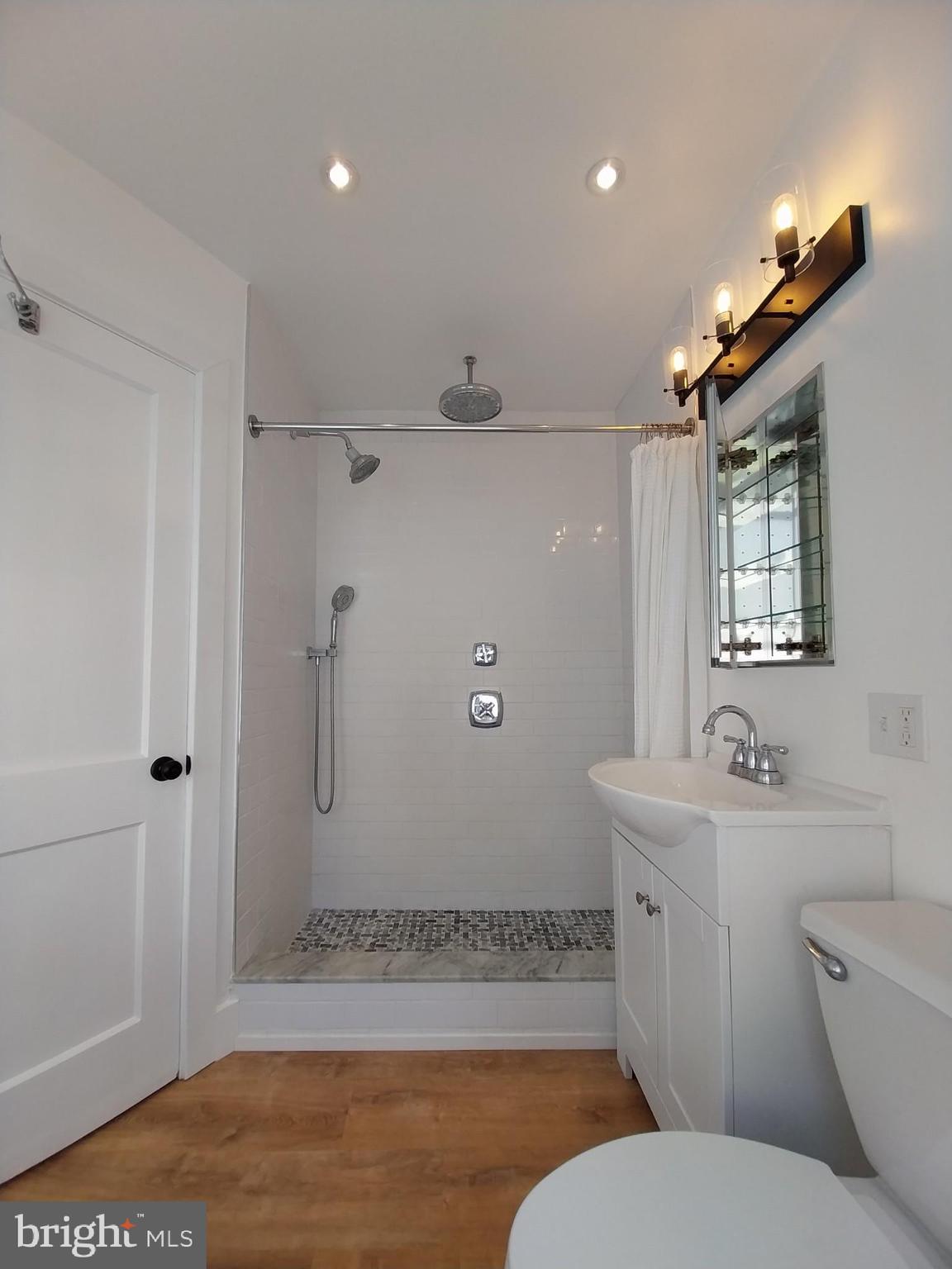 525 New Street Spring City, PA 19475 - Photo 9 of 11 a bathroom with a toilet a sink and mirror