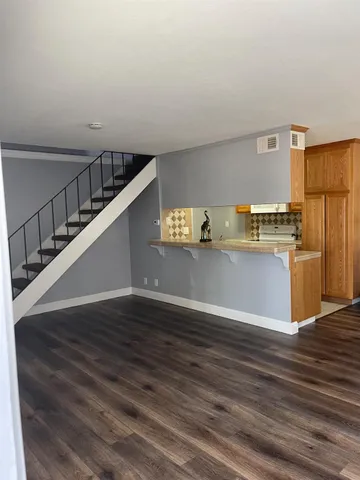 a view of a kitchen with wooden floor