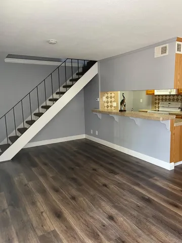 a view of a room with wooden floor
