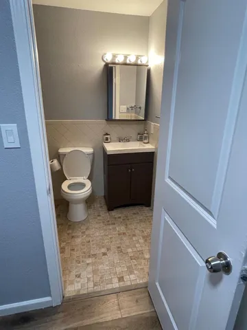 a bathroom with a sink toilet and mirror