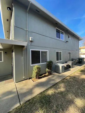 a front view of a house with yard and seating space
