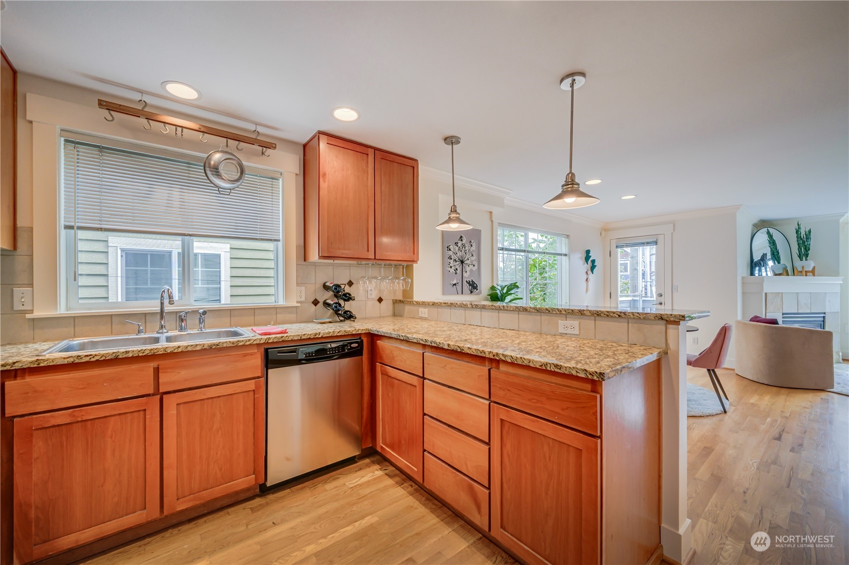 508 North 46th Street, Unit B Seattle, WA 98103 - Photo 10 of 30 a kitchen with granite countertop cabinets stainless steel appliances a sink and a wooden floor