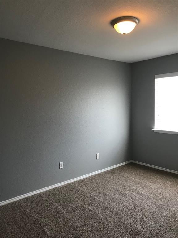 3305 Rustic Meadow Trail Mansfield, TX 76063 - Photo 9 of 12 Room featuring grey textured walls, brown flecked carpet, white baseboards, and a single window with white trim