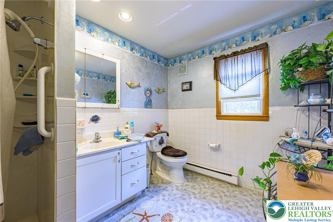 678 Interchange Road Kresgeville, PA 18333 - Photo 29 of 45 A charming bathroom with clean tile work and ample natural illumination from the window.