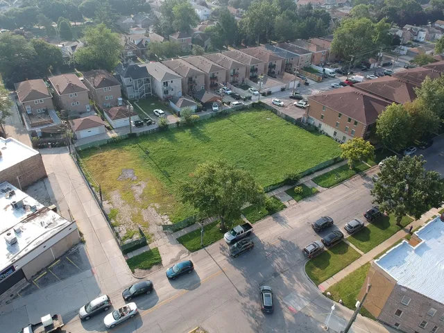an aerial view of a house with a garden and swimming pool