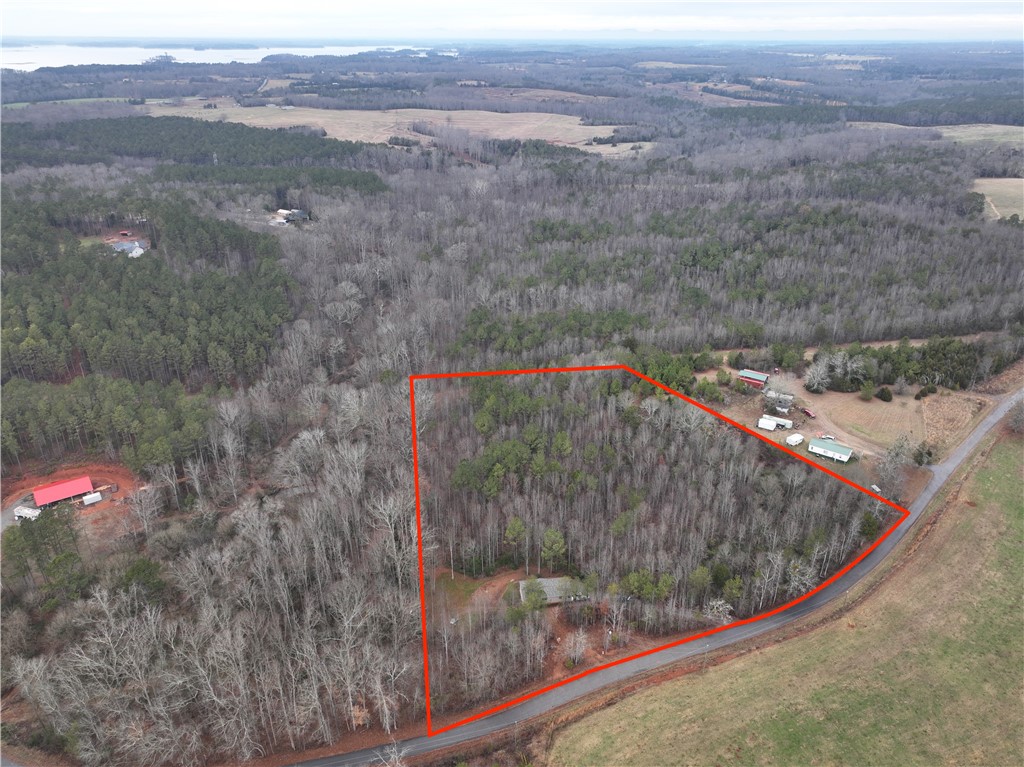 This aerial view showcases a wooded lot, offering ample space for development or private enjoyment.