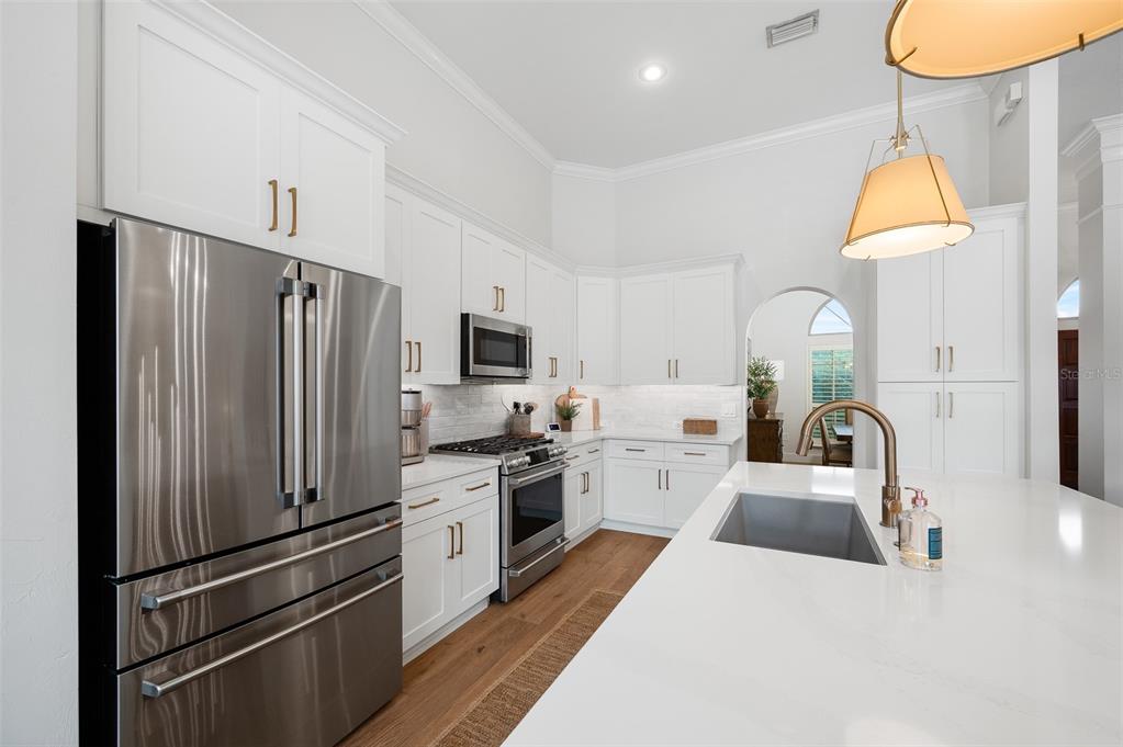 13549 Northwest 9 Road Newberry, FL 32669 - Photo 13 of 42 a kitchen with stainless steel appliances granite countertop a refrigerator sink and stove