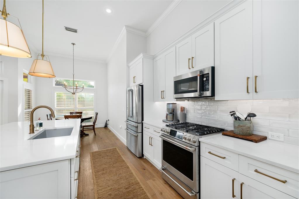 13549 Northwest 9 Road Newberry, FL 32669 - Photo 14 of 42 a kitchen with stainless steel appliances a microwave a sink a stove and cabinets