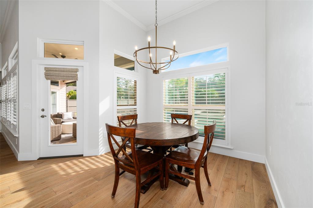 13549 Northwest 9 Road Newberry, FL 32669 - Photo 15 of 42 a dining room with furniture a chandelier and wooden floor