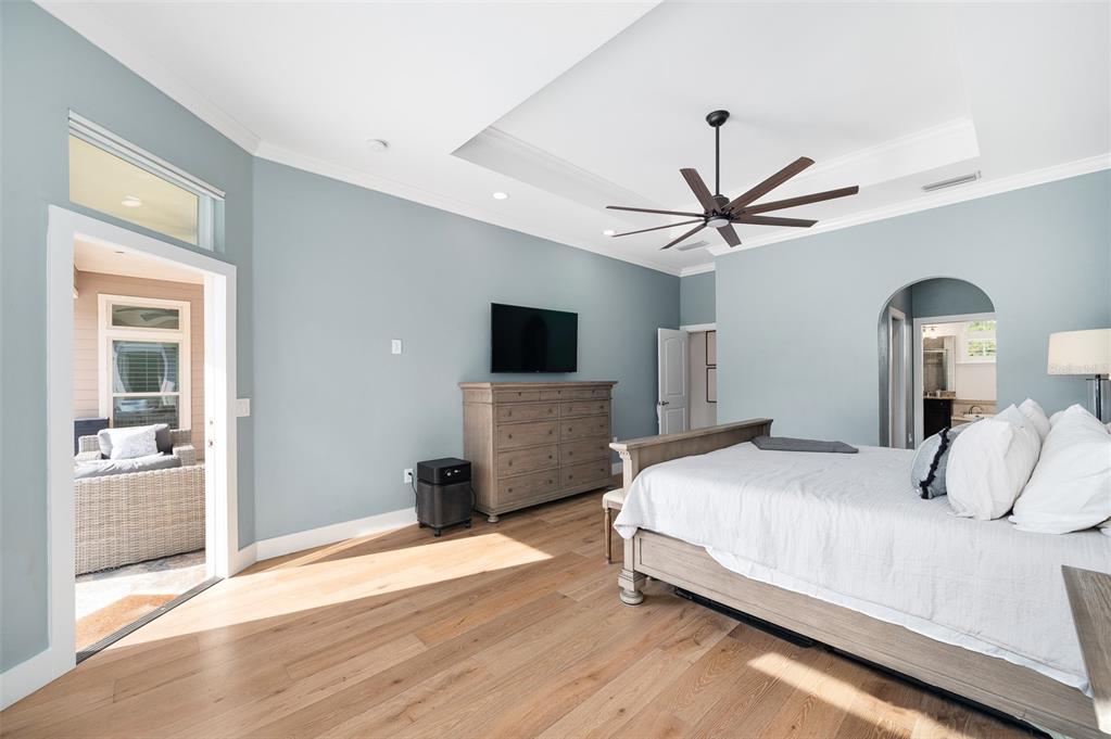 13549 Northwest 9 Road Newberry, FL 32669 - Photo 19 of 42 a bedroom with a large bed and a flat screen tv