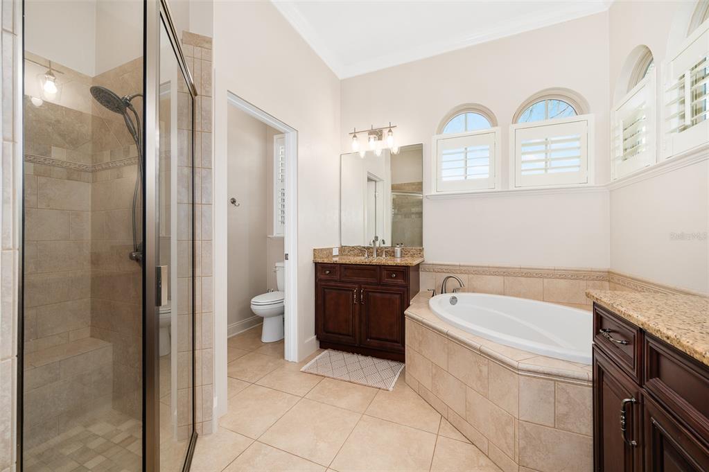 13549 Northwest 9 Road Newberry, FL 32669 - Photo 23 of 42 a spacious bathroom with a tub sink and mirror
