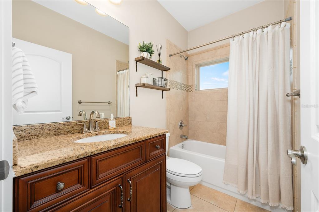 13549 Northwest 9 Road Newberry, FL 32669 - Photo 27 of 42 a bathroom with a granite countertop sink toilet and shower