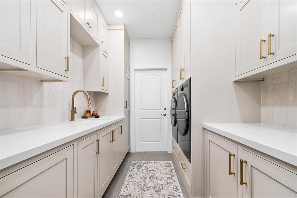 13549 Northwest 9 Road Newberry, FL 32669 - Photo 31 of 42 a kitchen with a sink and refrigerator
