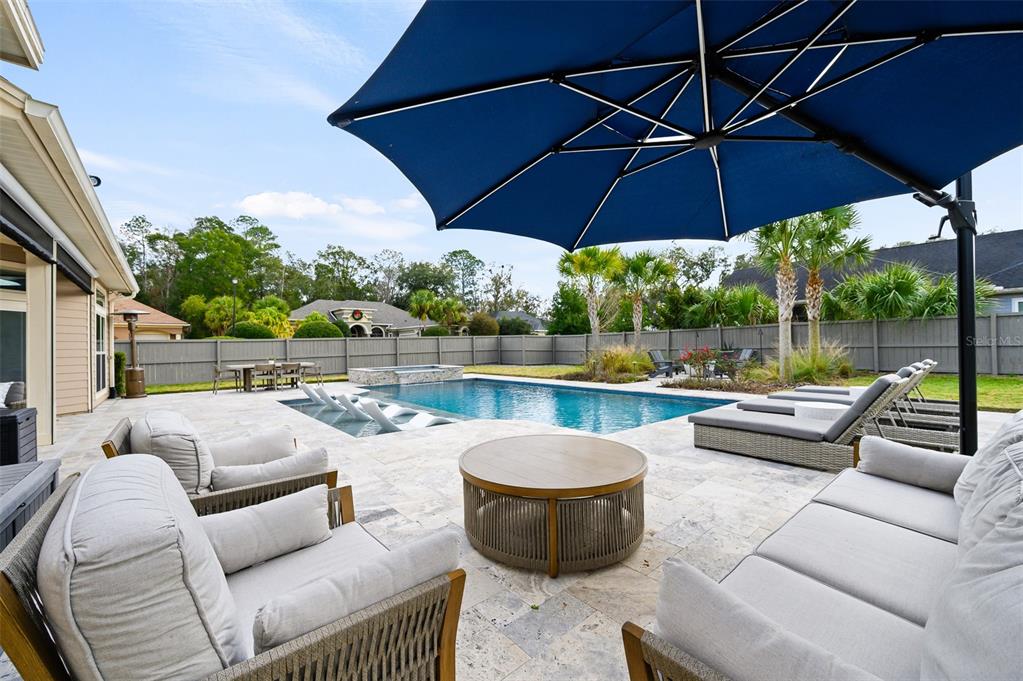 13549 Northwest 9 Road Newberry, FL 32669 - Photo 34 of 42 a view of a patio with couches under an umbrella