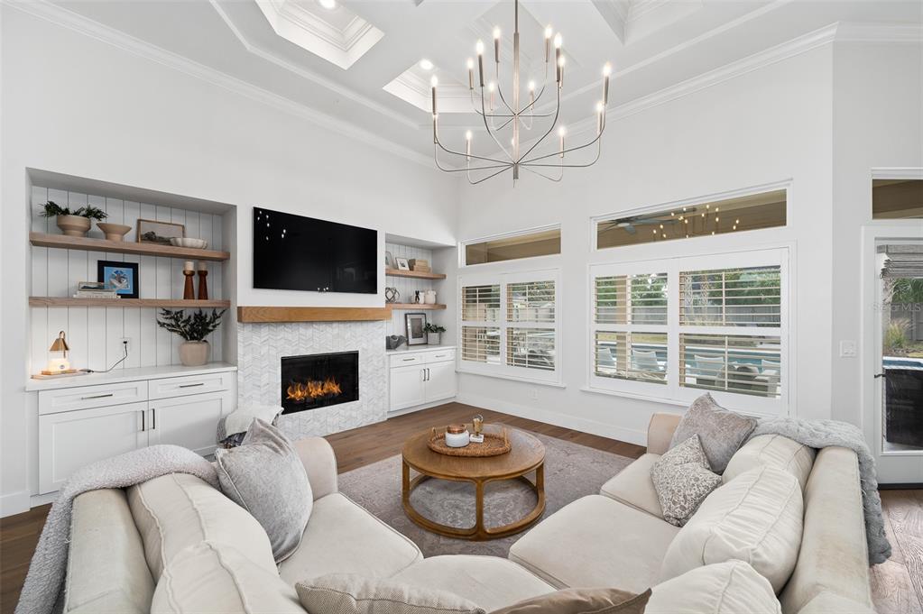 13549 Northwest 9 Road Newberry, FL 32669 - Photo 8 of 42 a living room with furniture a fireplace and a flat screen tv