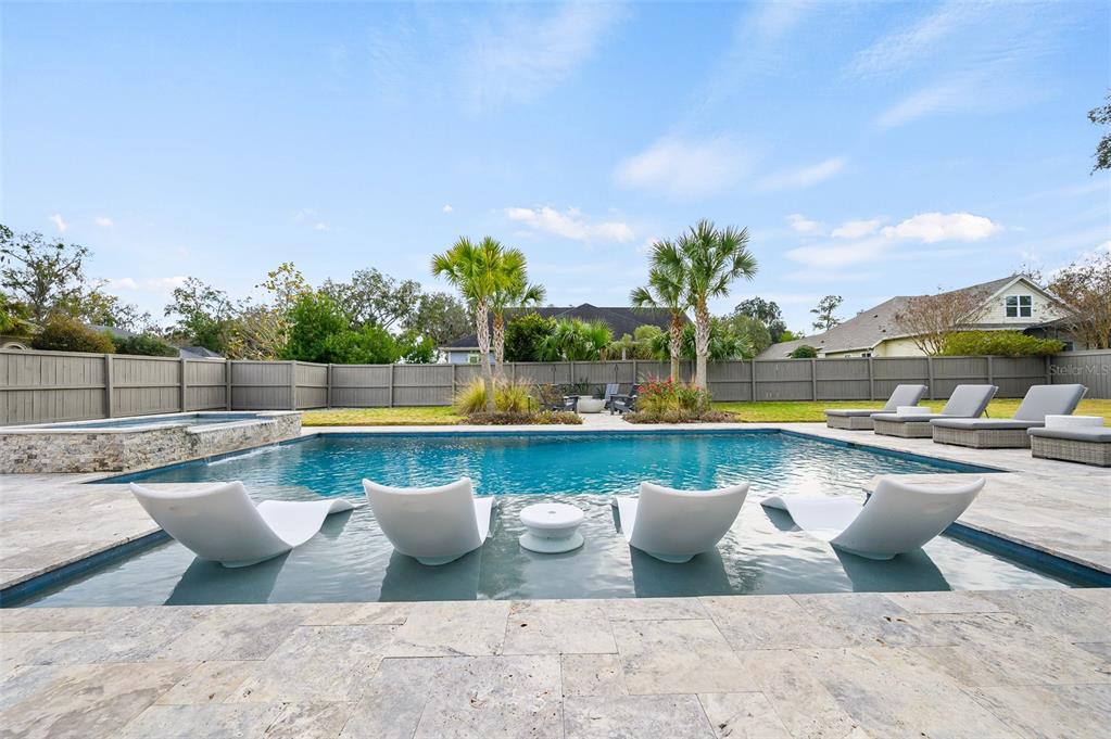 13549 Northwest 9 Road Newberry, FL 32669 - Photo 9 of 42 a view of swimming pool with outdoor seating and plants