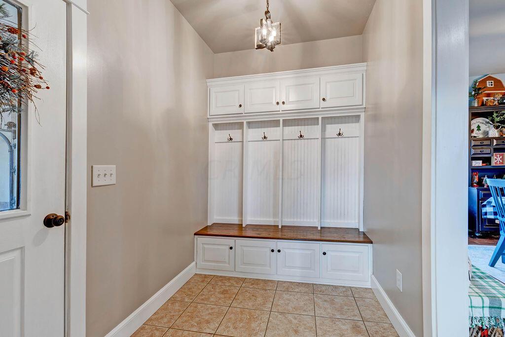 4045 Russell Road Mount Gilead, OH 43338 - Photo 20 of 74 • Ceramic tile flooring • Tan painted walls • Built in lockers • Ceiling light