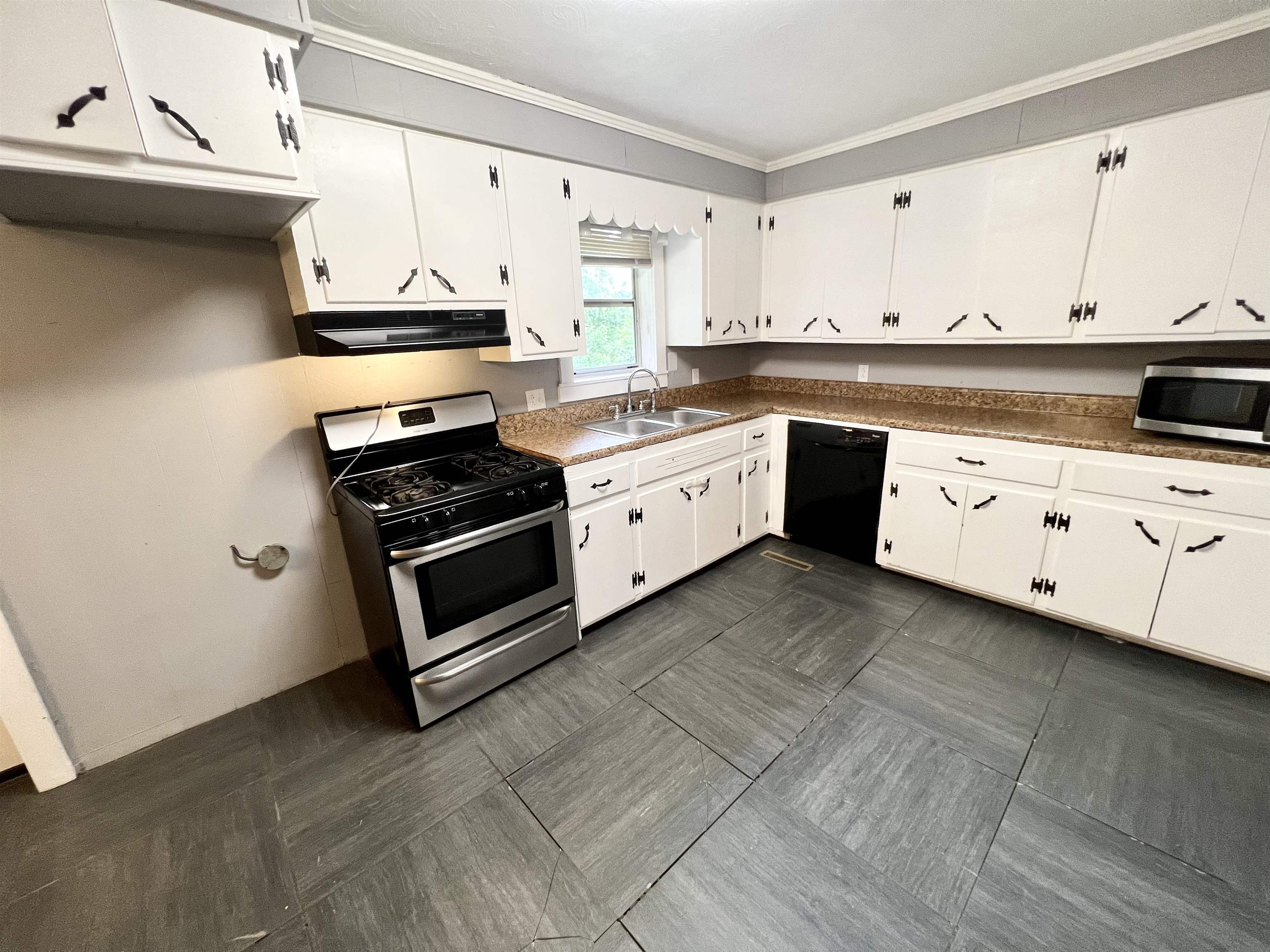 161 Miller Street Ripley, TN 38063 - Photo 3 of 10 a kitchen with stainless steel appliances a stove a sink and cabinets