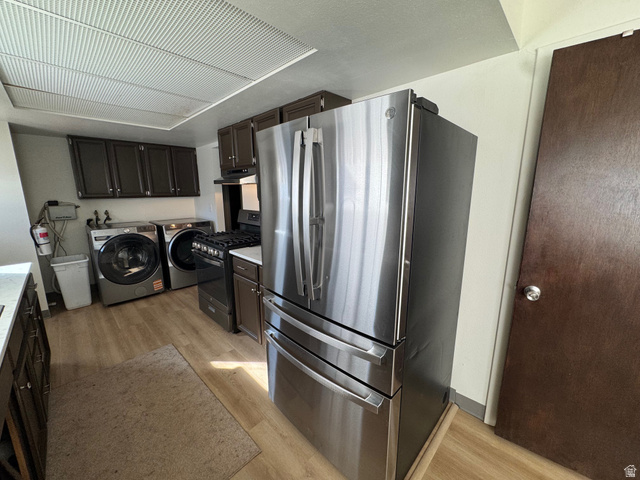 527 Palisade Drive Moab, UT 84532 - Photo 48 of 51 Kitchen featuring stainless steel appliances, light wood-type flooring, dark wood finish cabinetry, and washer and dryer