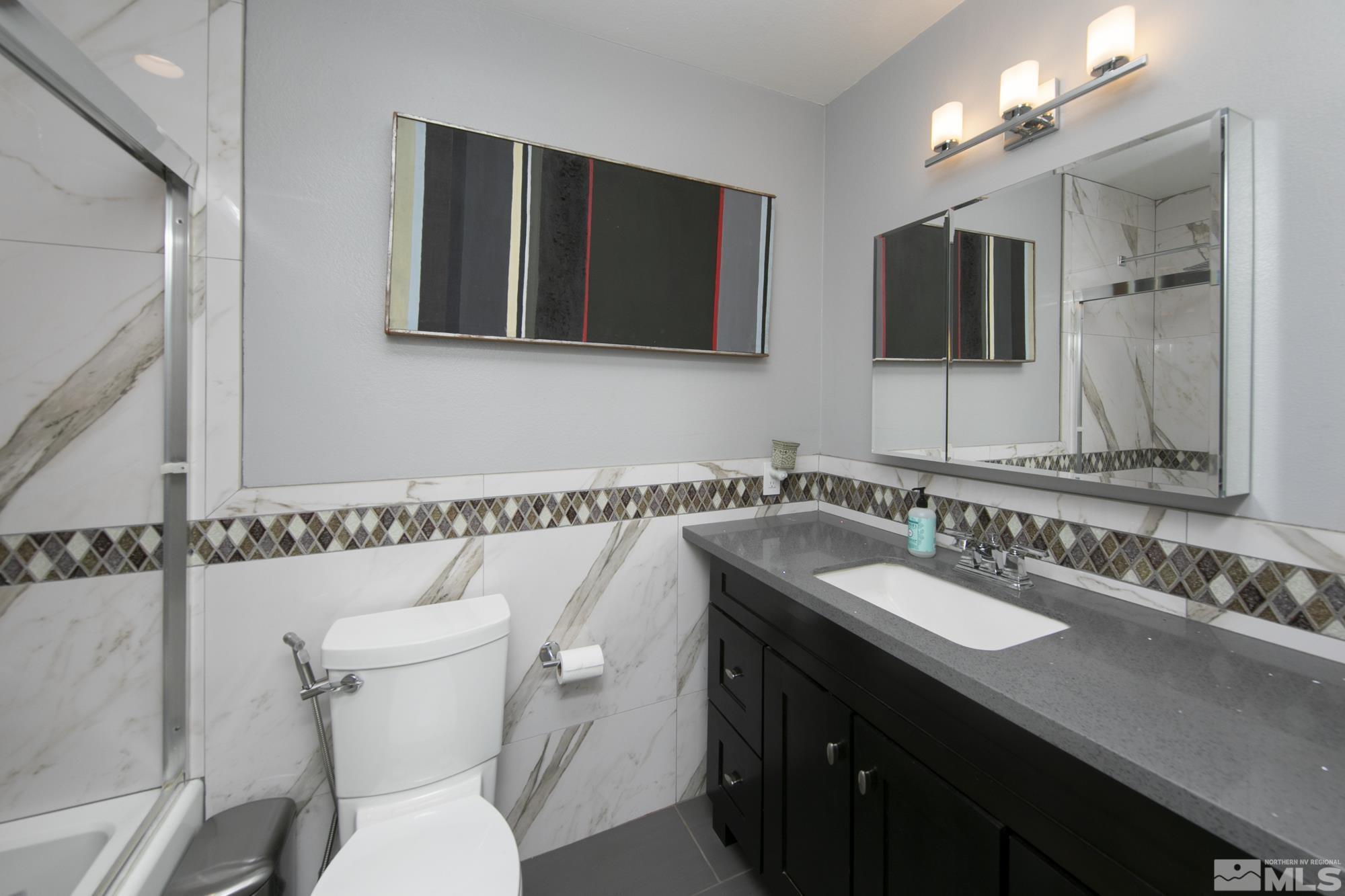 3475 Bryan Street Reno, NV 89503 - Photo 12 of 20 a bathroom with a sink and a mirror