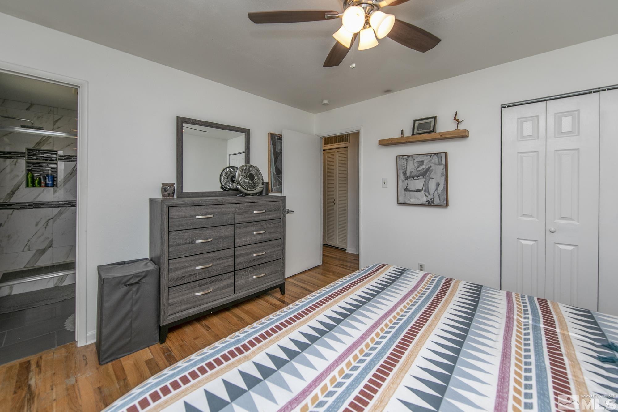 3475 Bryan Street Reno, NV 89503 - Photo 14 of 20 a bedroom with a bed and a chandelier