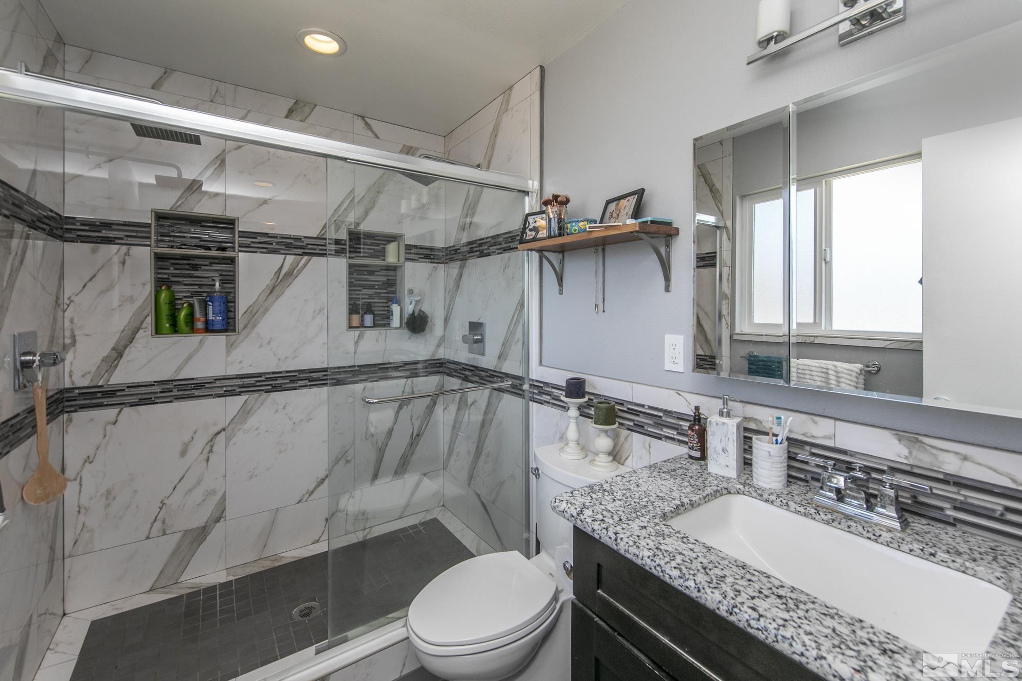 3475 Bryan Street Reno, NV 89503 - Photo 15 of 20 a bathroom with a granite countertop sink toilet and a mirror