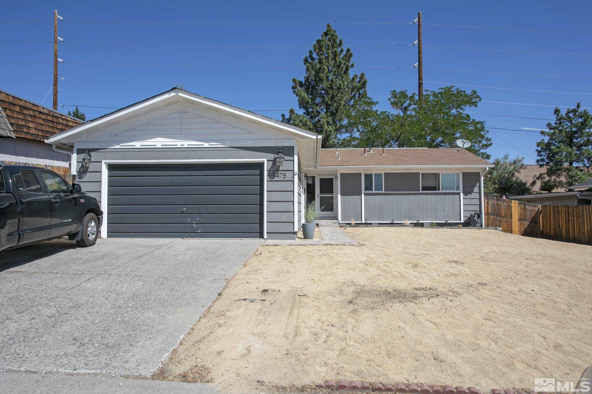 3475 Bryan Street Reno, NV 89503 - Photo 2 of 20 a front view of a house with a yard and garage