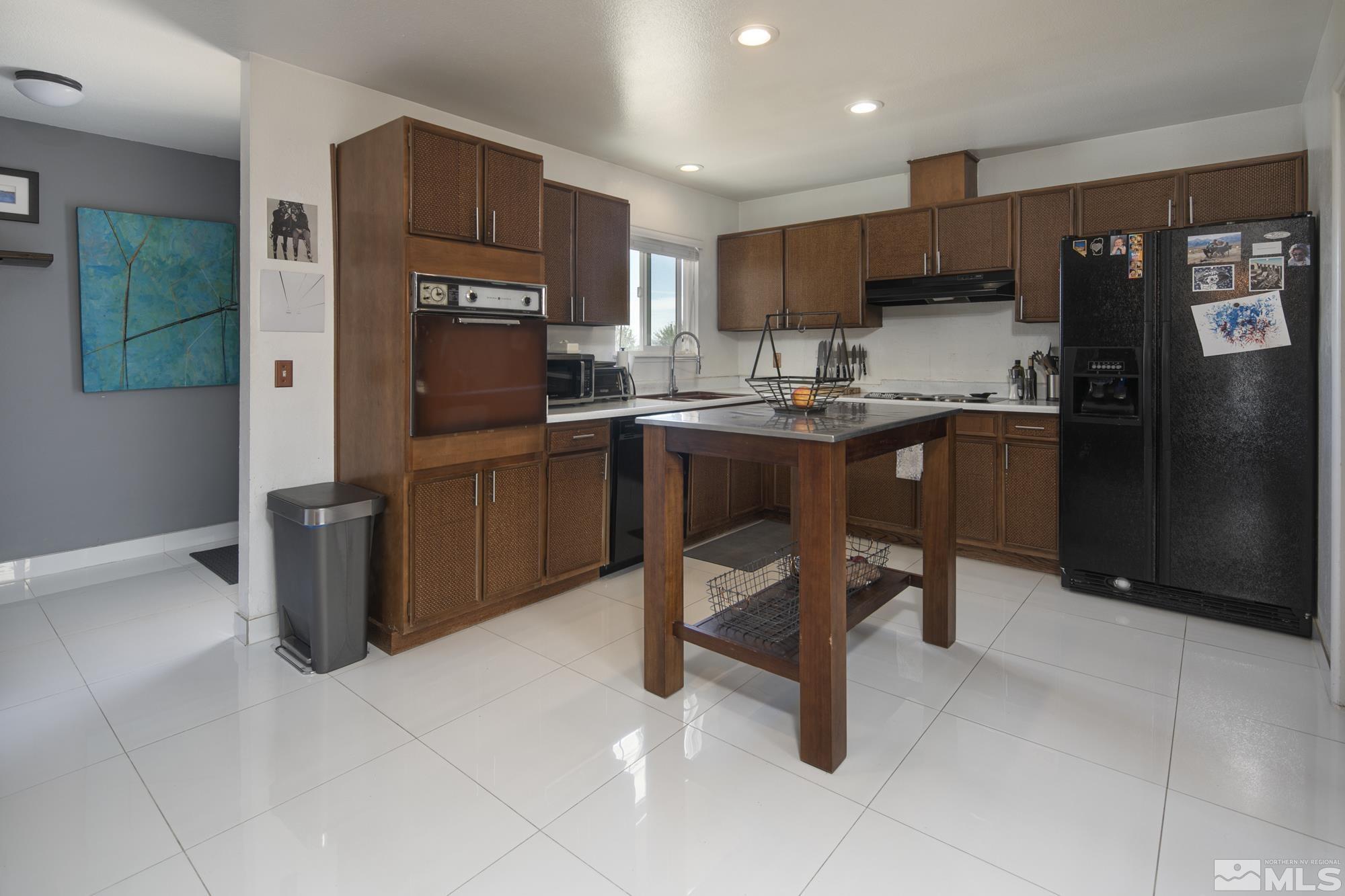 3475 Bryan Street Reno, NV 89503 - Photo 3 of 20 a kitchen with a sink a counter top space appliances and cabinets
