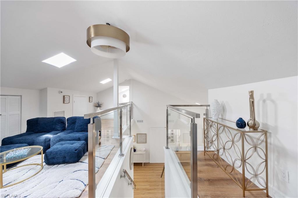 4732 West Boulevard, Unit E5 Naples, FL 34103 - Photo 16 of 40 Bathroom featuring lofted ceiling and wood-type flooring