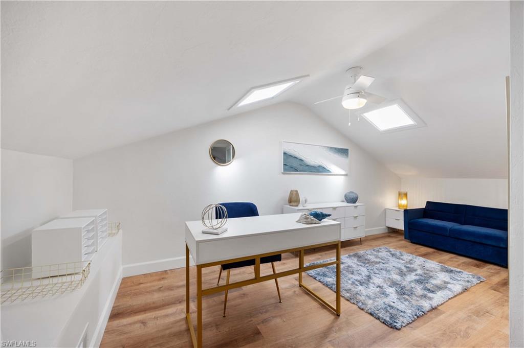 4732 West Boulevard, Unit E5 Naples, FL 34103 - Photo 19 of 40 Home office with ceiling fan, lofted ceiling with skylight, and hardwood / wood-style floors